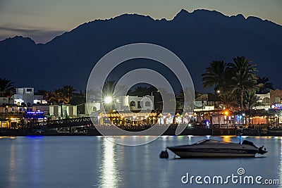 19/11/2018 Dahab, Egypt, incredibly beautiful sunset over a quiet bay in a beautiful spa town with a boat on the foreground Editorial Stock Photo