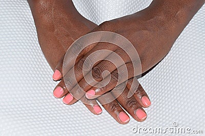 Dainty female hands with a pink manicure Stock Photo