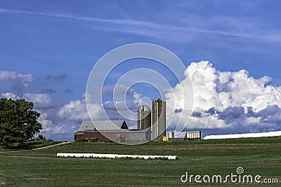 Dairy farm on a hill with blue sky - horizontal Stock Photo