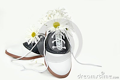 Daisy bouquet in saddle shoe Stock Photo