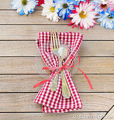 Daisy Flowers in Red White and Blue Colors as a Party Invitation Card Laying on Rustic Board Table with room or space for your wor Stock Photo