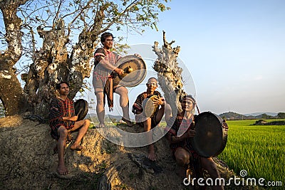 Daklak, Vietnam - Mar 9, 2017: Ede ethnic minority people perform traditional gong and drum dance in their festival under big tree Editorial Stock Photo