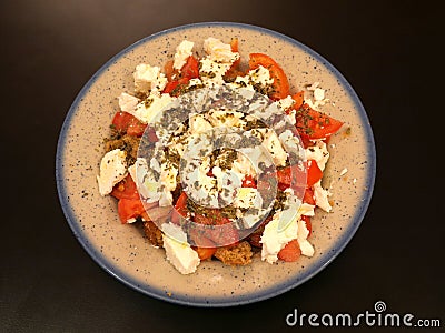 `Dakos` gourmet Greek salad with tomatoes, feta cheese and burley rusks Stock Photo