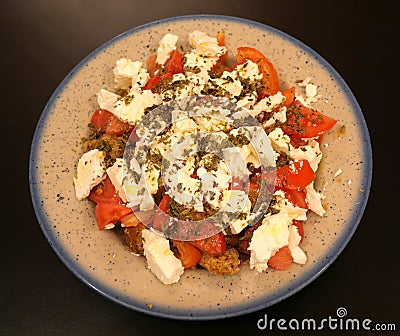 `Dakos` gourmet Greek salad with tomatoes, feta cheese and burley rusks Stock Photo