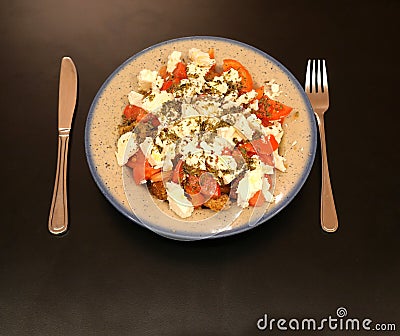 `Dakos` gourmet Greek salad with tomatoes, feta cheese and burley rusks Stock Photo