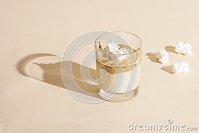 Dalgon coffee in a transparent glass with milk on a pastel background with marshmallows Stock Photo