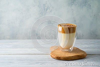 Dalgona coffee or whipped coffee drink with milk on wooden table Stock Photo