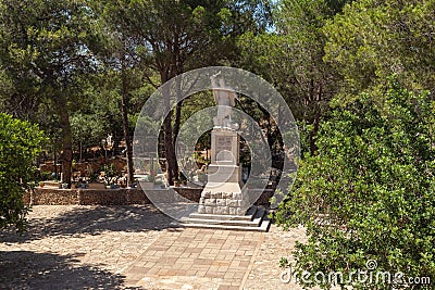 Large stone statue of Elijah - the Prophet stands on a stone pedestal in the garden of the Deir Al-Mukhraqa Carmelite Monastery in Editorial Stock Photo
