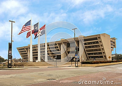 Dallas City Hall with American, Texas, and Dallas Flags in front Stock Photo