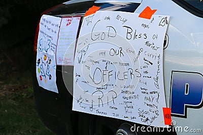 Dallas, TX/USA - July 2016 : Dallas Sniper Attack Aftermath. Sympathy covered Dallas Police Car Editorial Stock Photo