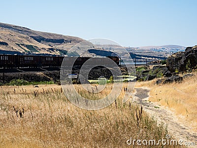 Freight train running along Columbia River Gorge in eastern Washington State Editorial Stock Photo