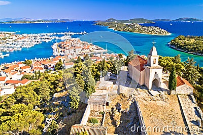 Dalmatian town of Tribunj church on hill and amazing turquoise archipelago aerial view Stock Photo