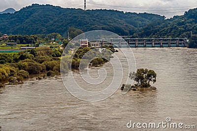 Dam across river with surging water and flooding Stock Photo