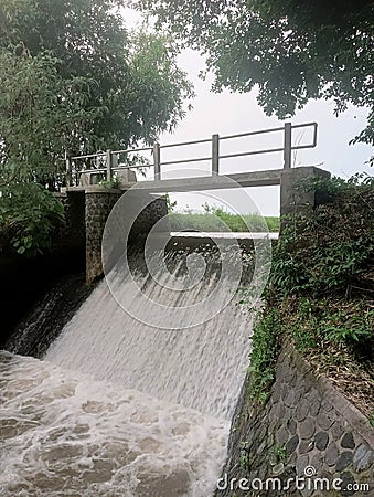 a dam that functions to regulate water for irrigation in farmers& x27; rice fields Stock Photo
