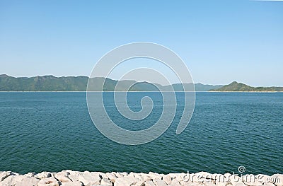 Dam pond, mountains and blue sky Stock Photo