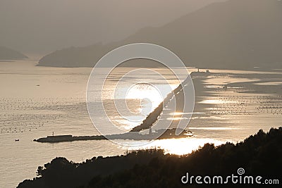 Dam of the port of La Spezia that separates the gulf from the open sea. Reflections on the sea Stock Photo