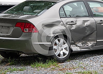 Damage to the rear panel, door and tire of a gray car due to an automobile accident. Editorial Stock Photo