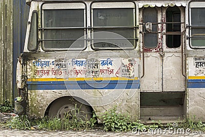 A damaged broken useless bus standing road side as a scrap Editorial Stock Photo