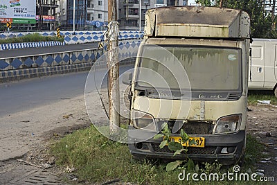 A damaged broken useless car standing road side as a scrap Editorial Stock Photo