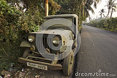 A damaged broken useless police car standing road side as a scrap Editorial Stock Photo