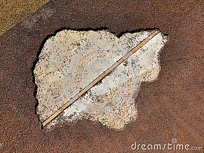 Damaged brown rubber coating of playground. Old sports texture, top view Stock Photo