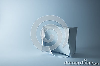 damaged paper box on the blue background. 3D handmade Stock Photo