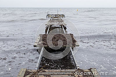 Damaged pier after flood storm in Vallensbaek Denmark 20 October 2023 Koge bugt, Stock Photo