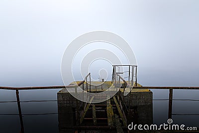 Damaged pier in the mist at morning Stock Photo