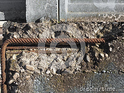 Damaged reinforced concrete with exposed rebar Stock Photo
