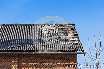 Damaged tile on the roof Stock Photo