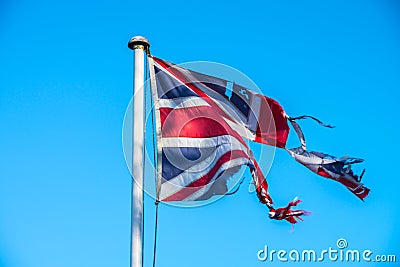 Damaged Union Jack Flag symbol of the disharmony within UK over Brexit Stock Photo