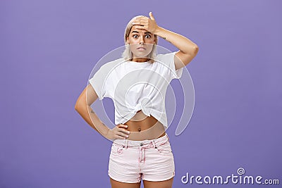Damn I am in trouble. Worried troubled good-looking stylish female employee with tanned skin and fit body holding hand Stock Photo