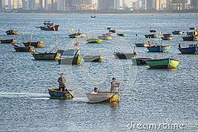 Vietnamese fisherman in a traditional round bamboo boat rowing to makeshift living rafts on the open sea near city of Danang, Editorial Stock Photo