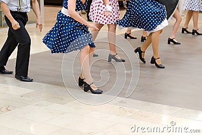 Dance group in vintage clothes dancing on marble Stock Photo