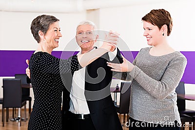 Dance instructor with senior couple Stock Photo