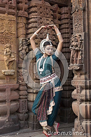 Odissi Dancer wears traditional costume and performs Odissi dance at Mukteshvara Temple,Bhubaneswar, Odisha, India Stock Photo