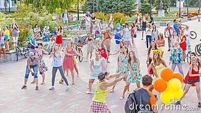 dancing beautiful and elegant stylish girls participating in the carnival costumed women`s bike ride in the summer evening Editorial Stock Photo