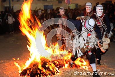 Dancing devotees with fire and masks in the procession of the vigen del carmen in the streets at night june Editorial Stock Photo
