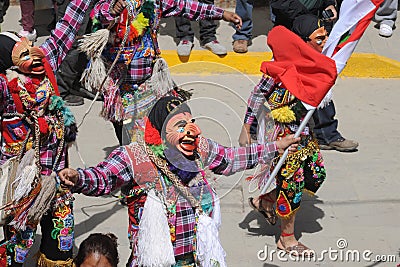 Dancing devotees with mask in the streets of the town the procession of the Virgin of Carmen -.Catholic religion Editorial Stock Photo