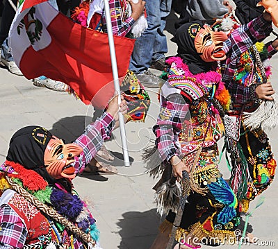 Dancing devotees with mask in the streets of the town the procession of the Virgin of Carmen -.Catholic religion Editorial Stock Photo