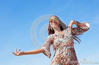 Dancing hippy girl with copy space in blue sky outdoor in summer Stock Photo