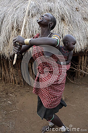 Dancing Mursi woman with baby in South Omo, Ethiopia. Editorial Stock Photo