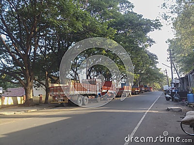 Commercial trucks lined up before loading materials. Morning scene at Dandeli Editorial Stock Photo