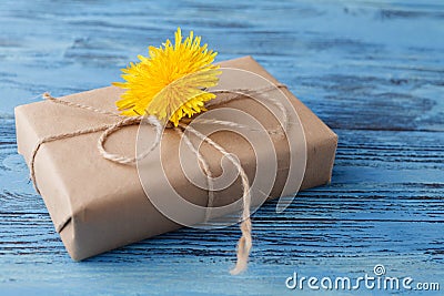 Dandelion flowers and gift box on wooden background Stock Photo