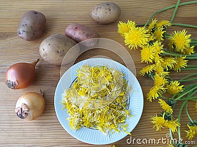 Dandelions flowers with potatoes and onion burgers Stock Photo