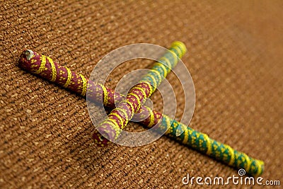 2 Dandiya sticks criss-crossed. Dandiya is the traditional folk dance of the state of Gujarat in India. Stock Photo