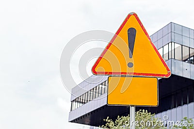 Danger ahead roadsign with blank sign to enter your text to raise attention, urban background Stock Photo