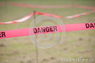 Danger Boundary Tape in a Field. Stock Photo