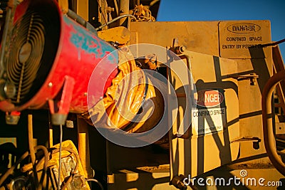 Danger confined space sign entry by permit only ventilation fan is inused Stock Photo