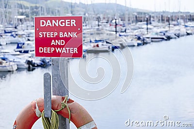 Danger deep water and steep bank at sea harbour marina Stock Photo